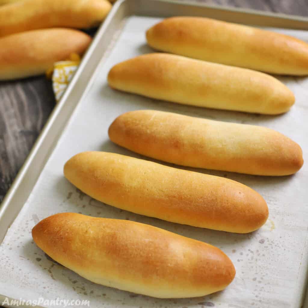 Buns on a baking sheet lined with parchment paper.