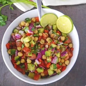 A close up look at a white bowl with chickpea salad