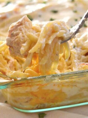 A fork taking some of the chicken tetrazzini out of the casserole.