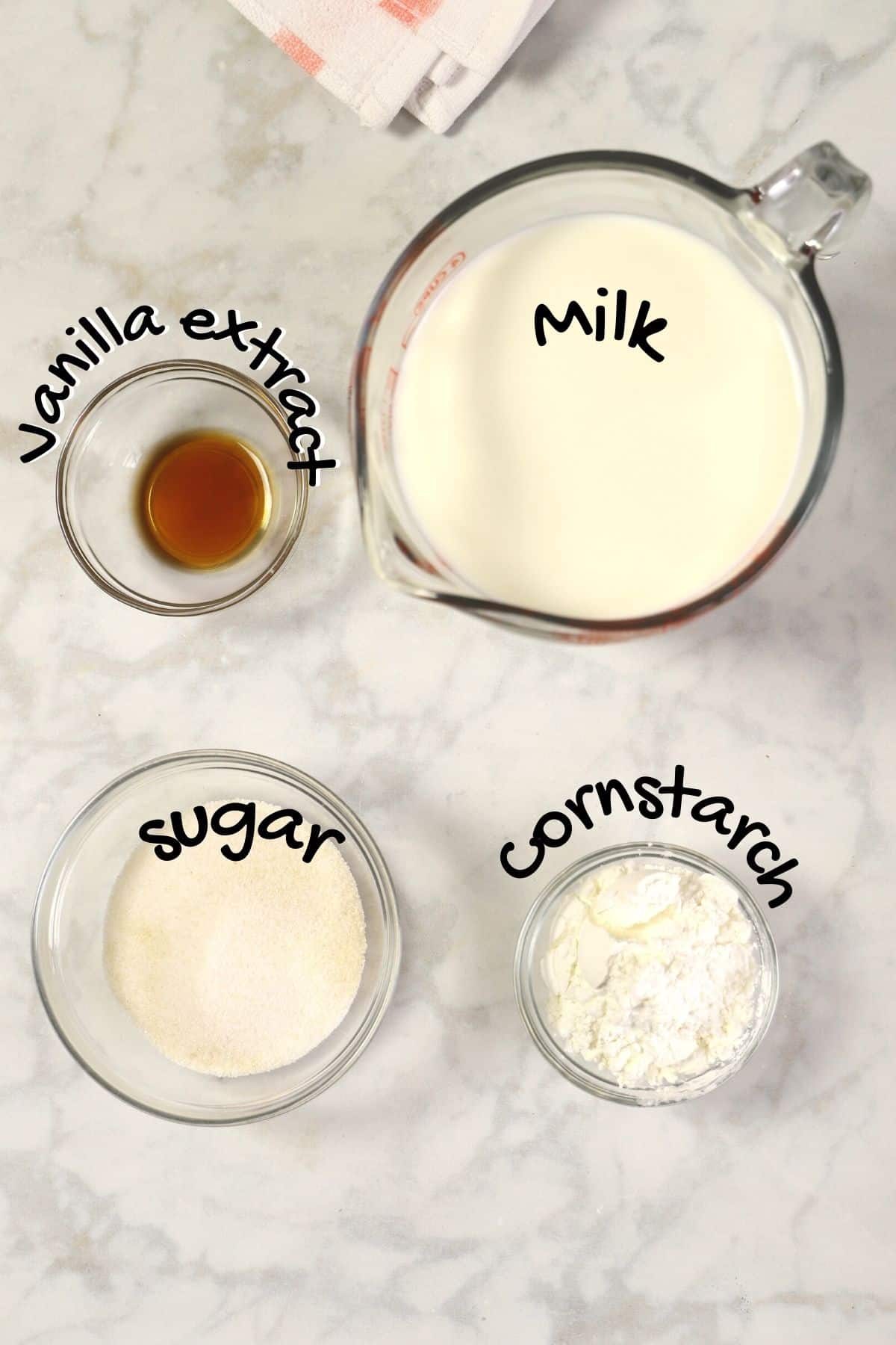 mahalabia ingredients placed on a white marble surface.