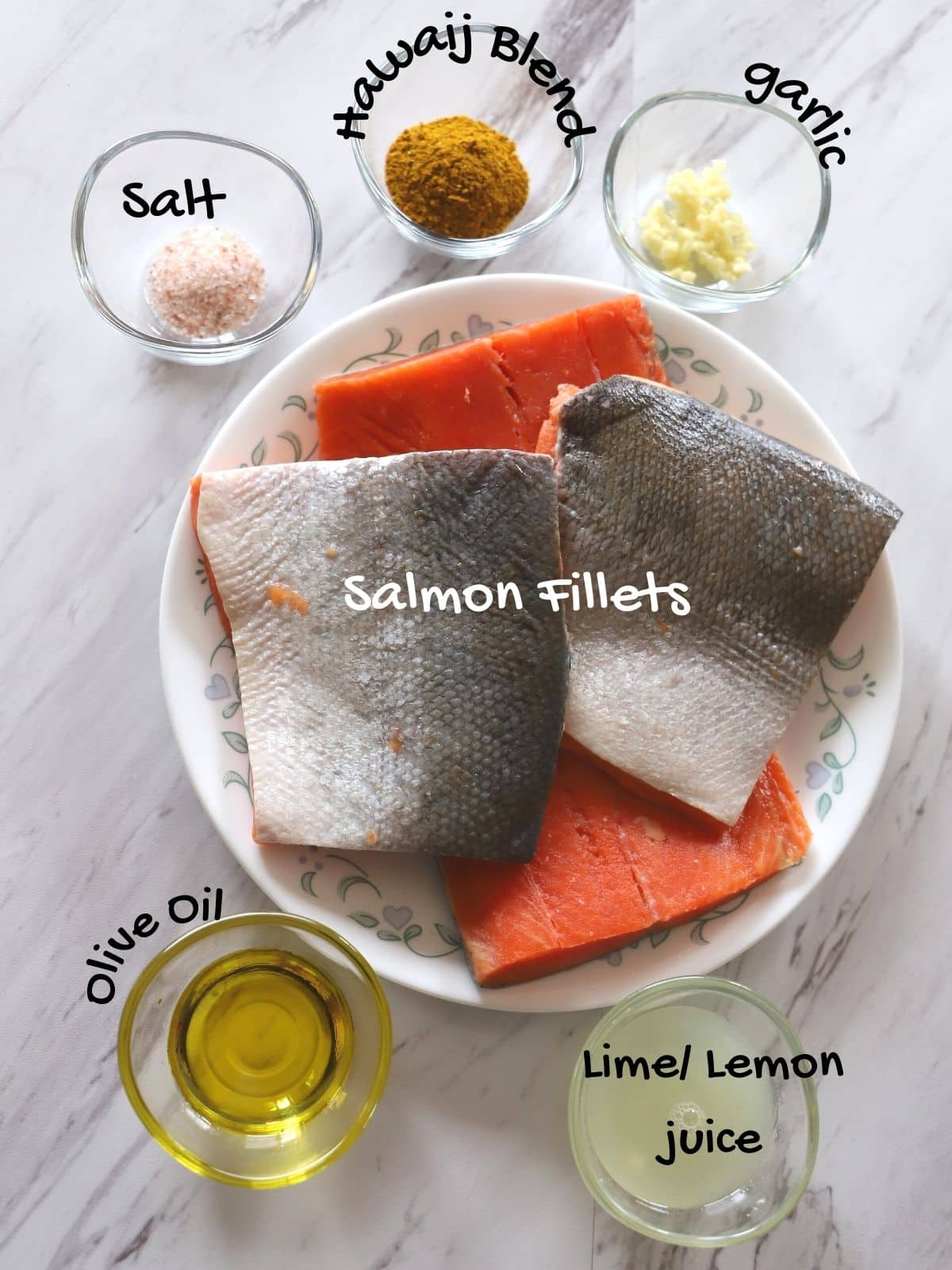 Air fryer salmon ingredients placed on a wgite surface.