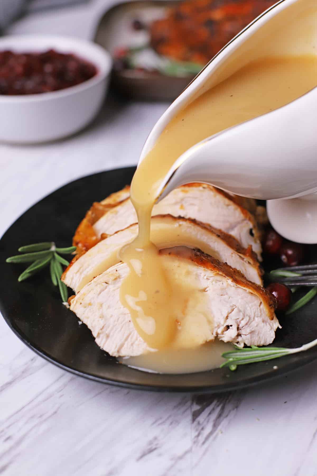 Gravy is poured over sliced turkey breast.
