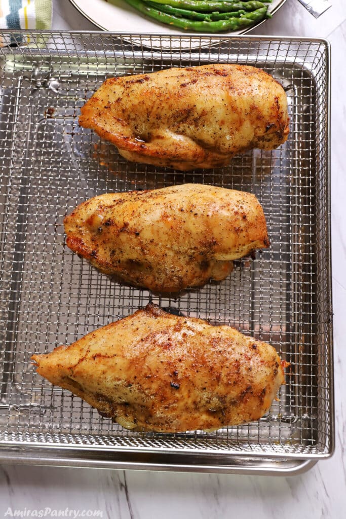 Stuffed chicken breast on an air fryer basket.