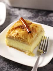 One galaktoboureko serving on a white dish with a fork.