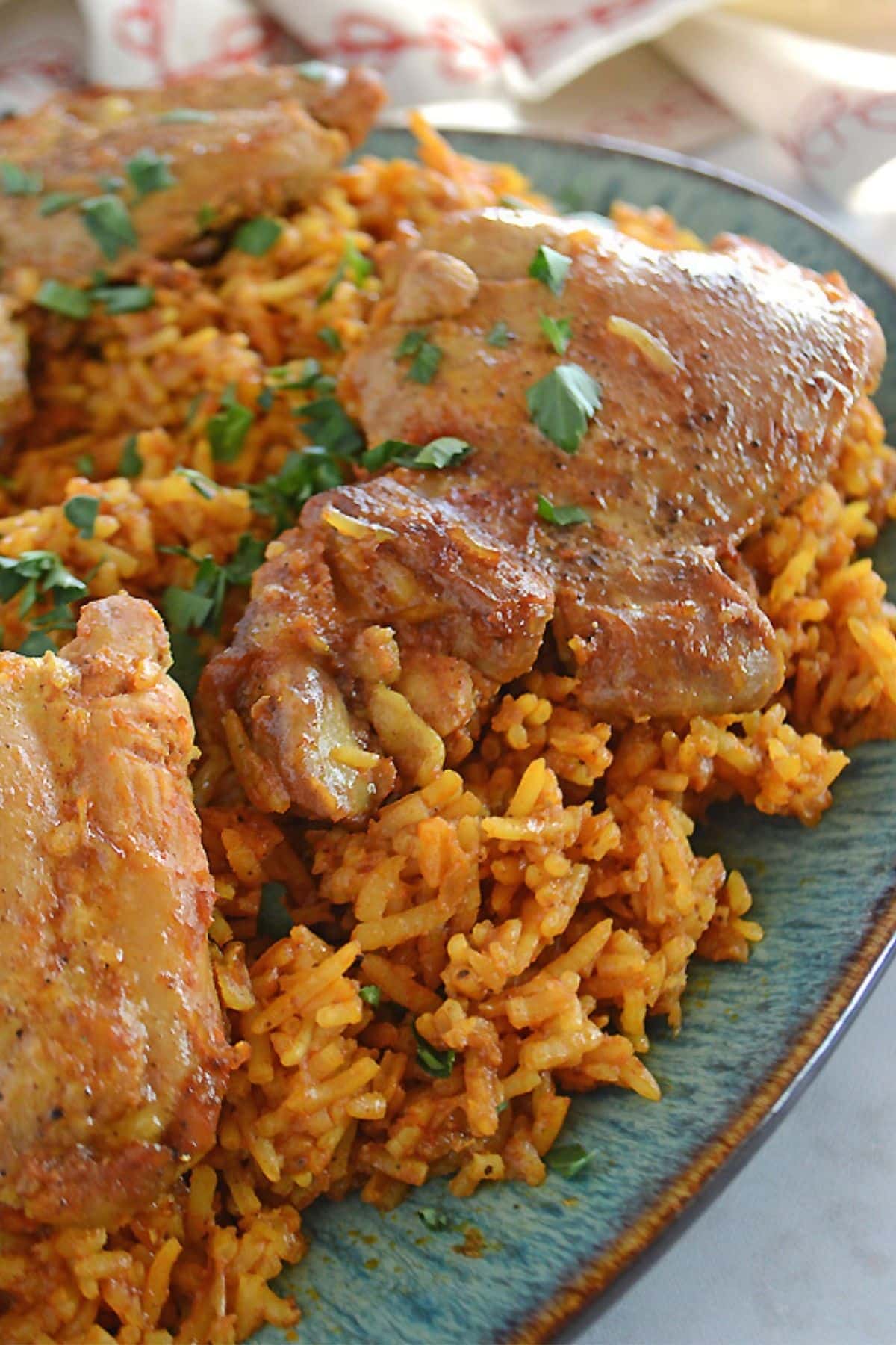 A side view of a big kabsa platter garnished with chopped parsley.