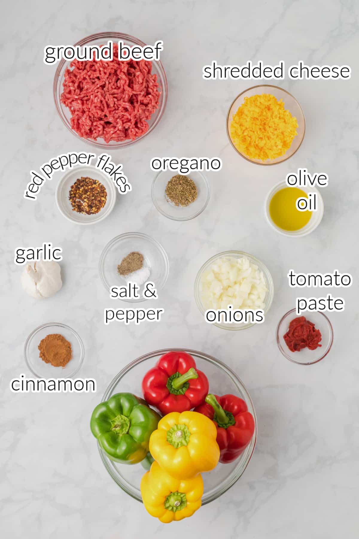 Keto stuffed peppers ingredients on a while surface.