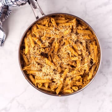 A bird's eye view of a skillet with sun dried tomato pasta.