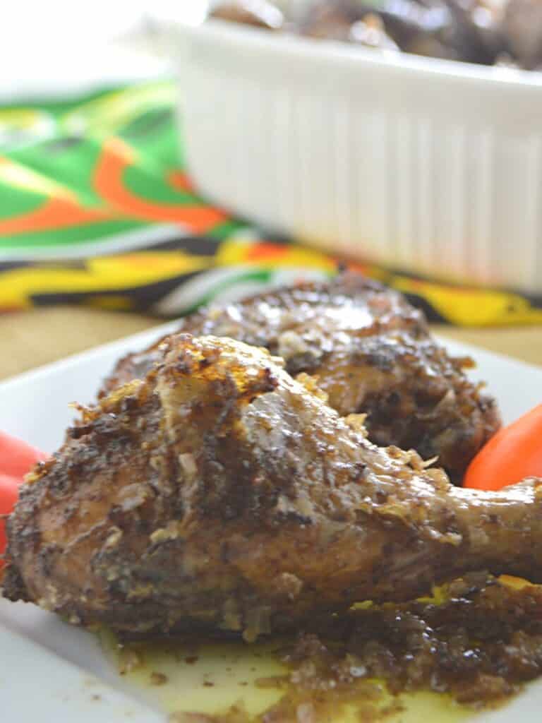 Chicken drumstick on a white plate.