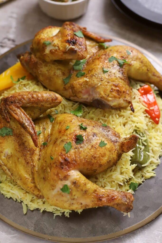 A close up look at a chicken mandi dish with rice.