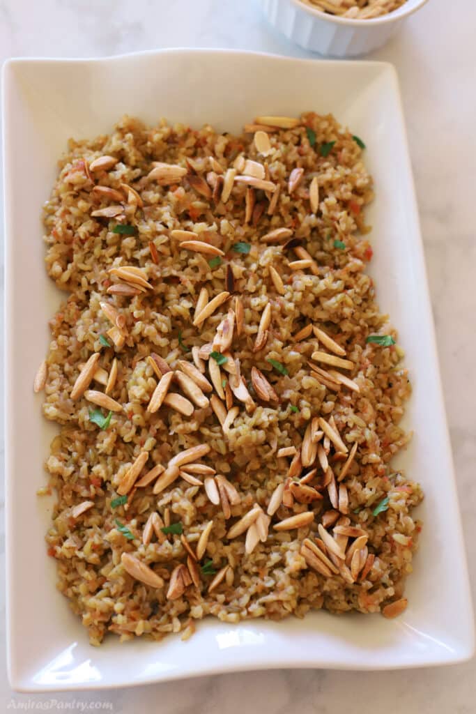 Freekeh on a white serving platter.