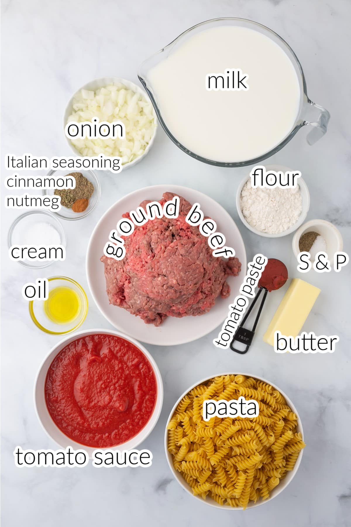 Pasta ingredients on a marble table.
