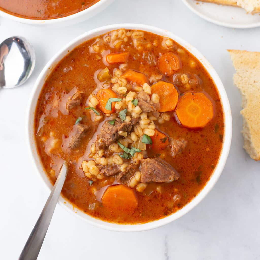 A bird's eye view of a bowl of barley soup.