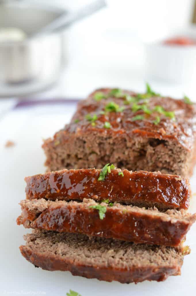 A sliced meatload on a white plate.