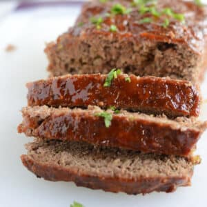 A sliced meatload on a white plate.