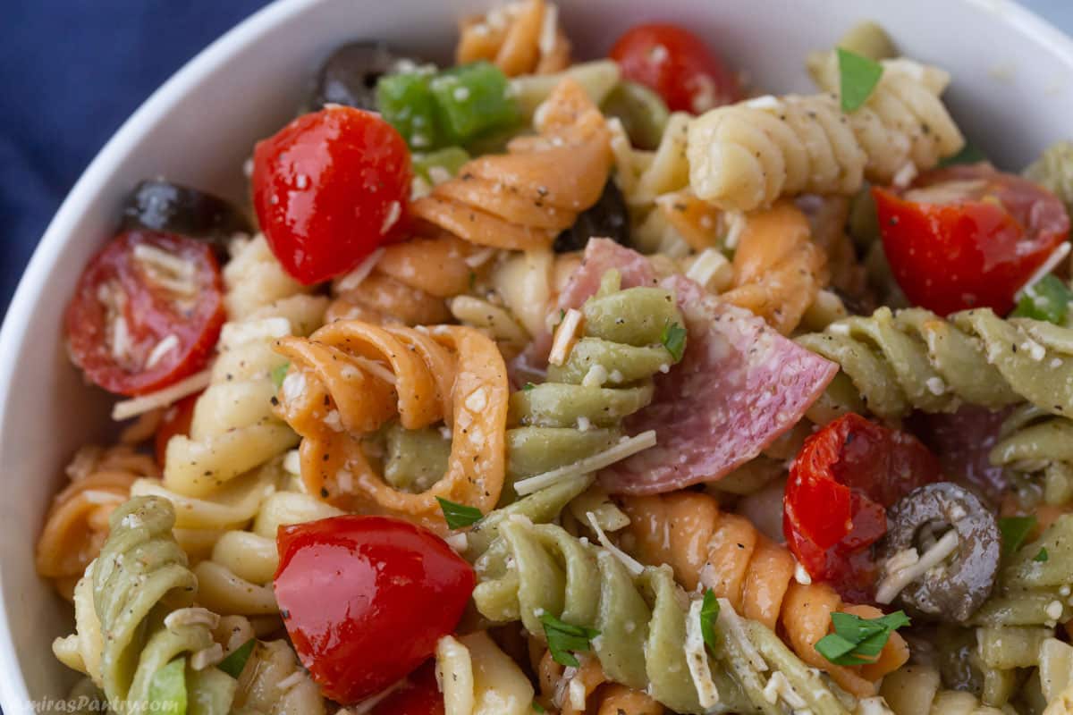 A zoomed image on a plate with Italian pasta salad.