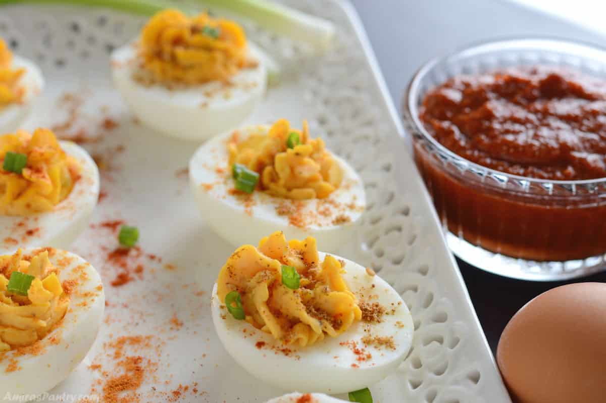 Deviled eggs placed on a white serving plate.