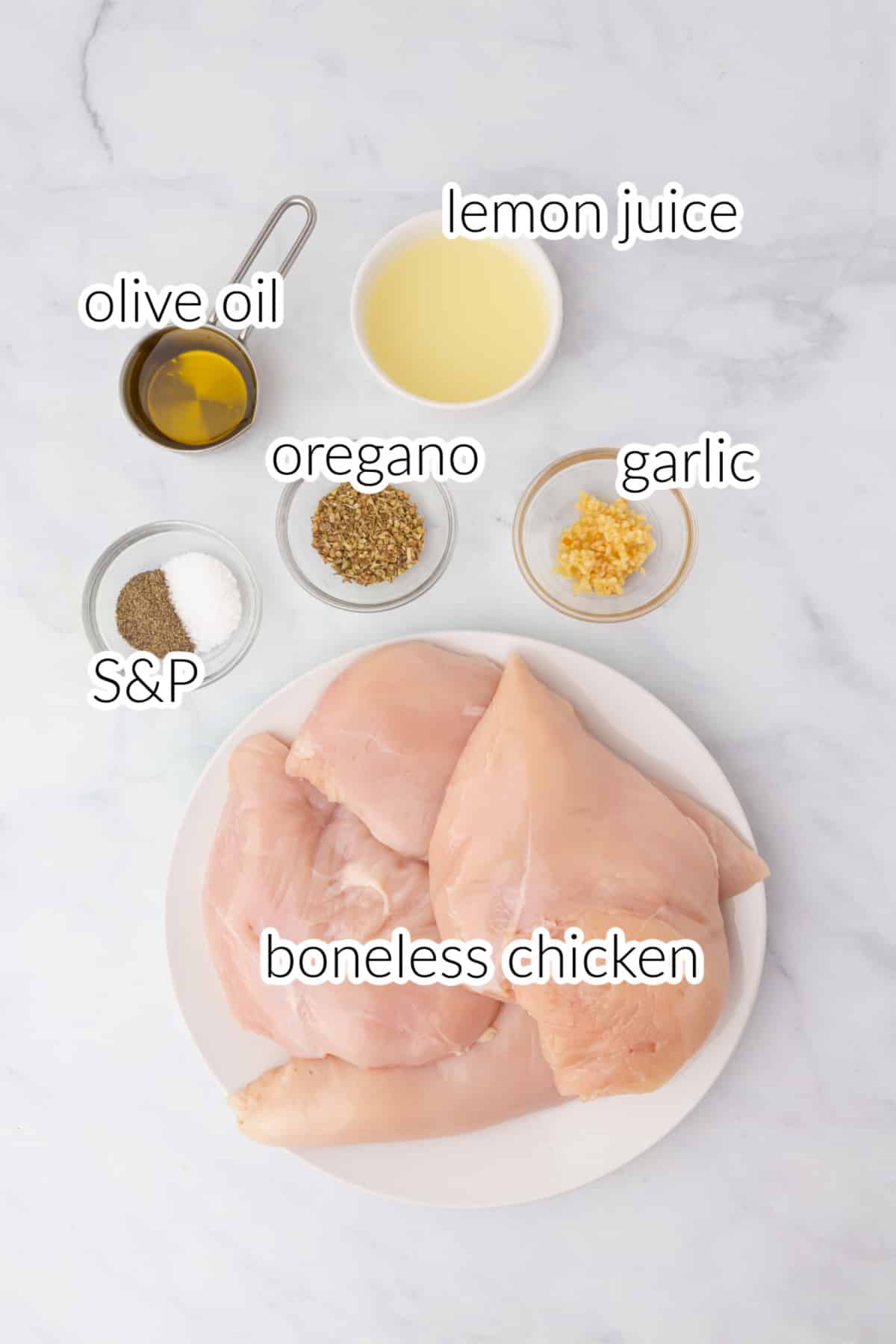 Oregano chicken ingredients on a white surface.