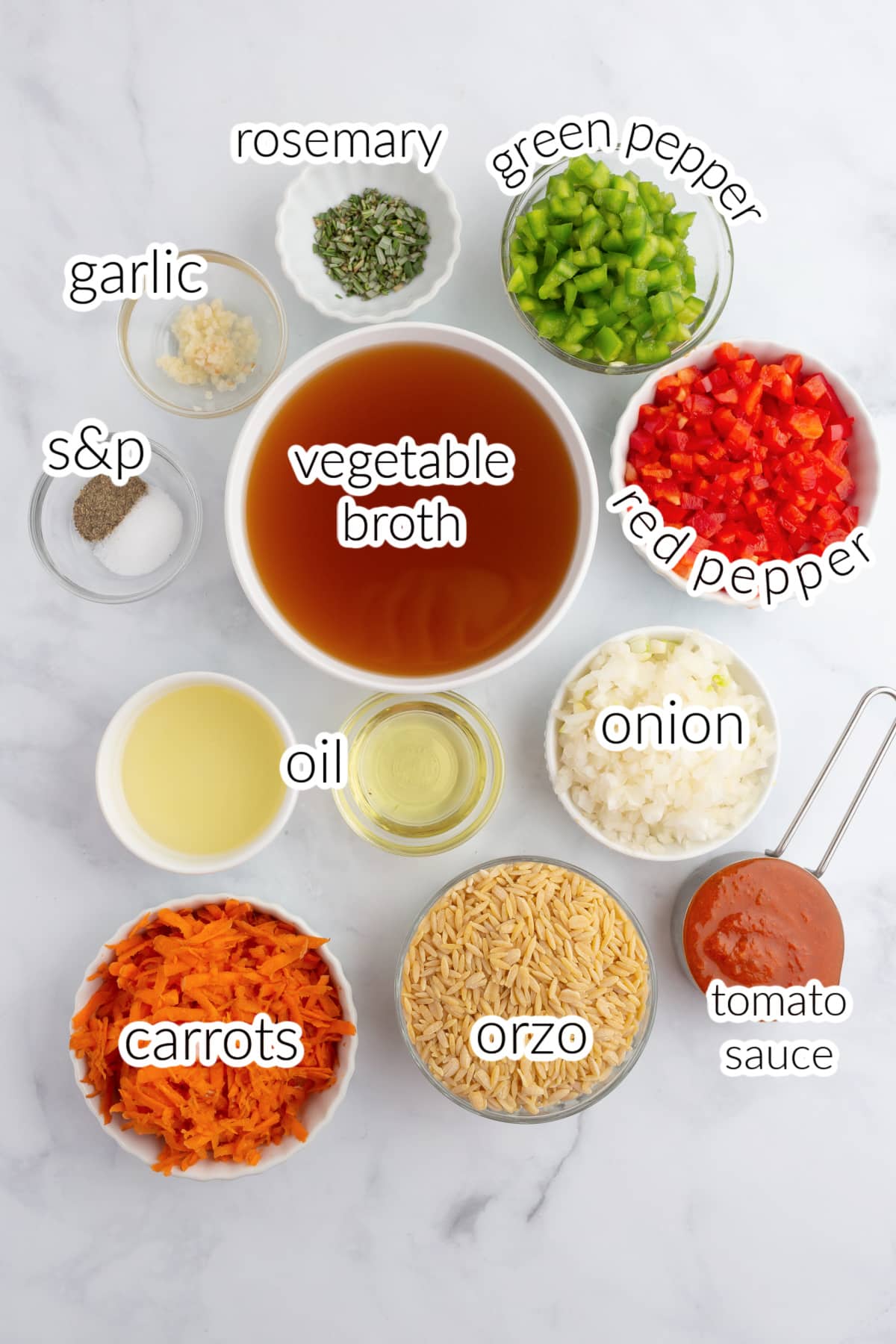 vegetarian orzo ingredients on a marble surface.