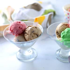 A glass with three ice cream scopps.
