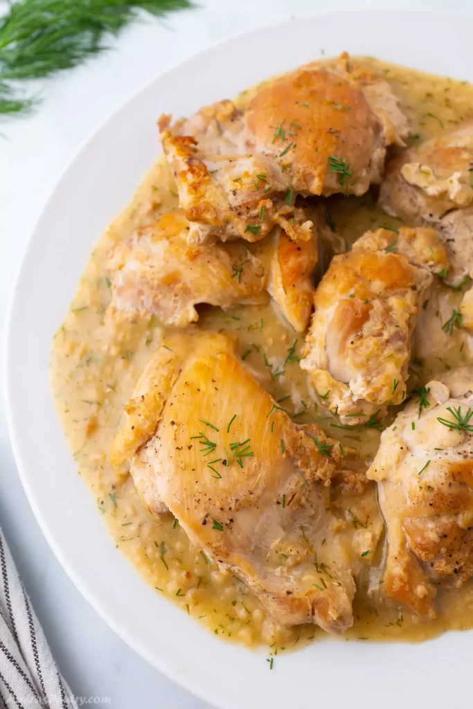 Lemon dill chicken on a white plate.