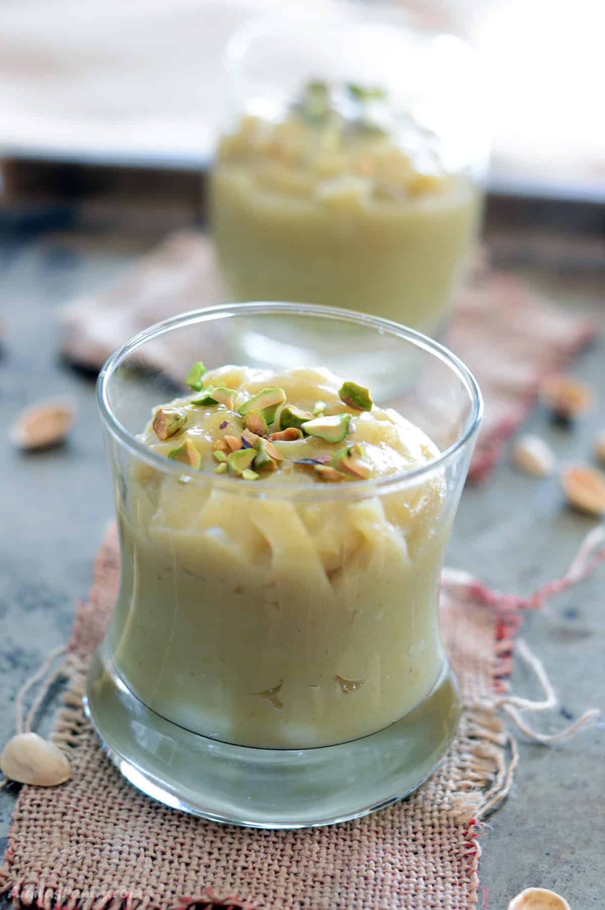 a close look at a cup with pistachio pudding.