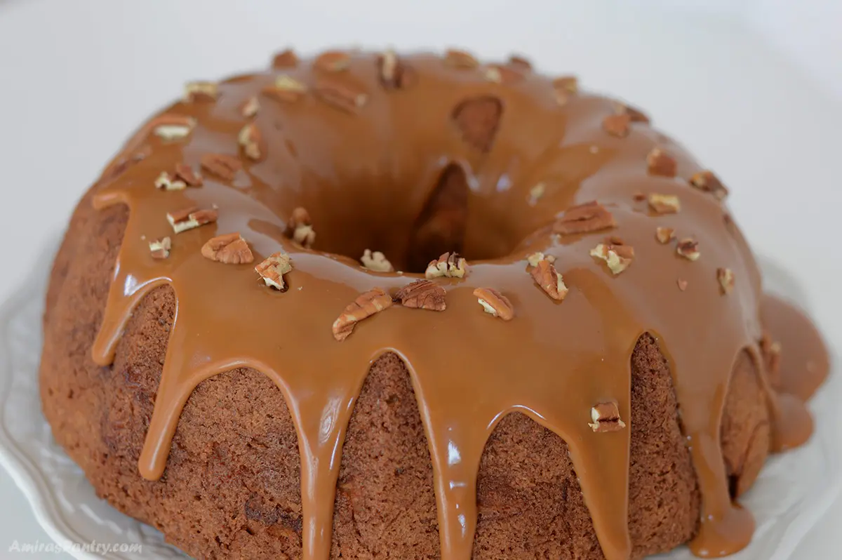 A close up look at a bundt cake with caramel sauce.