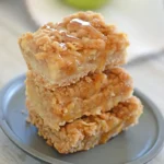 A stack of apple crisp bars on a small plate.