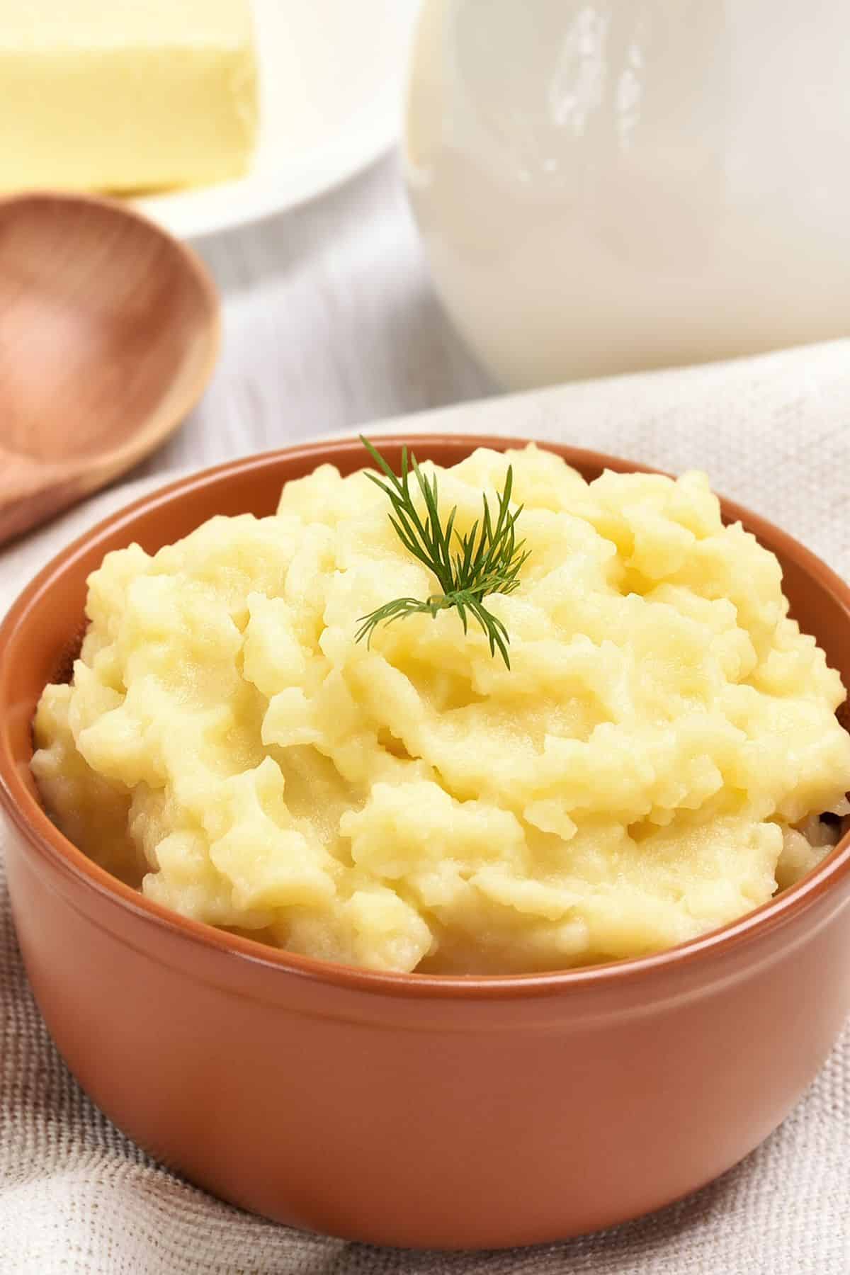 A close up look at a bowl of mashed potatoes.