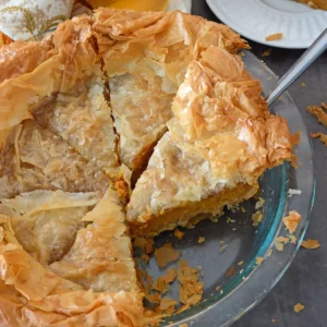 A plate of food on a table, with pumpkin Pie slices