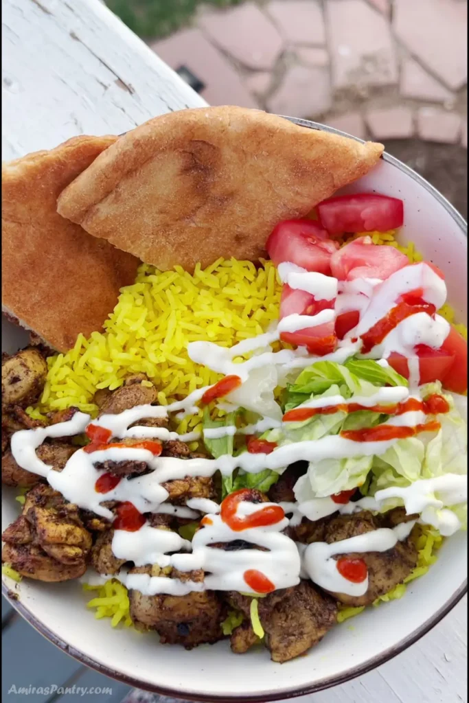 An overhead view of a Halal chicken and rice bowl.
