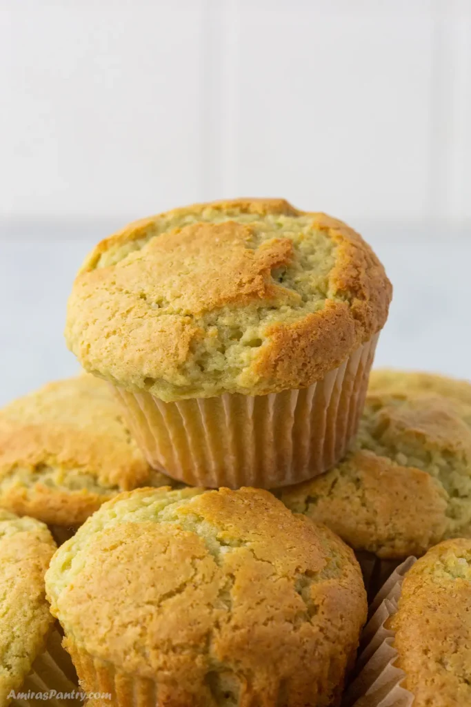 A stack of pistachip muffins on a white background.