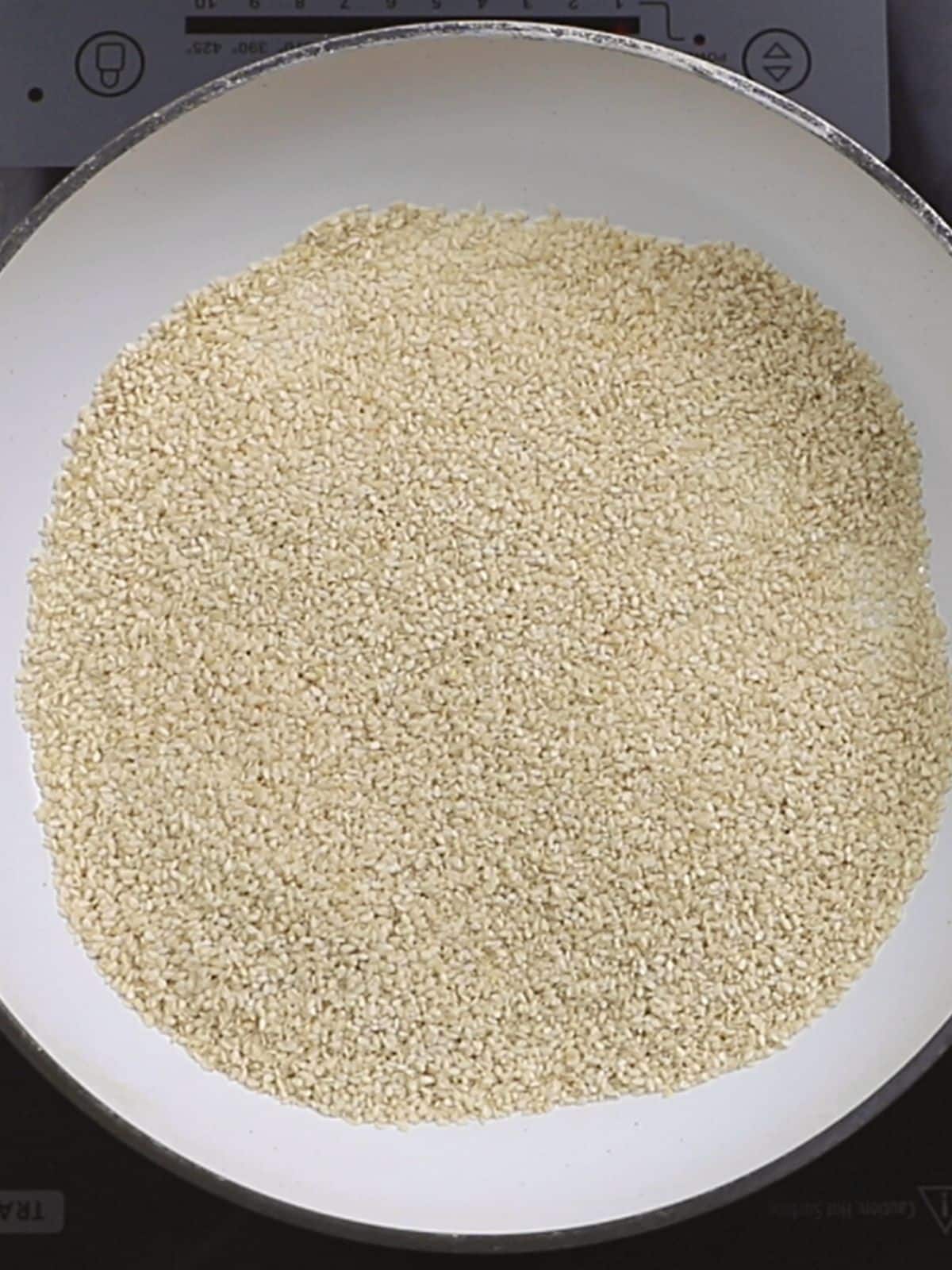 An images showing how to toast raw sesame seeds.