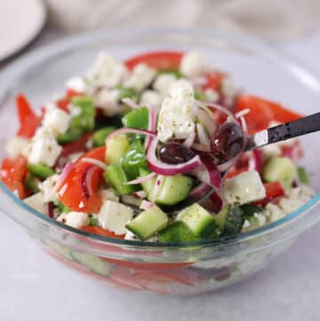 A close up look at a bowl of Greek salad.