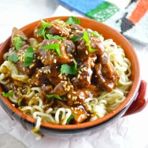 Tamarind chicken in a bowl over pasta.