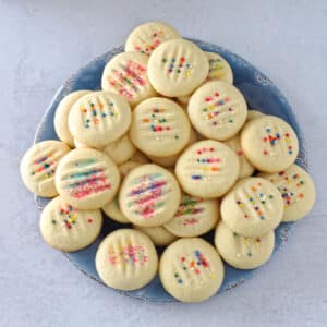 A top view of shortbread cookies stacked on a blue plate.
