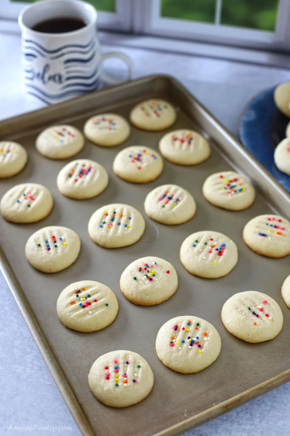 Whipped shortbread cookies on a baking sheet.