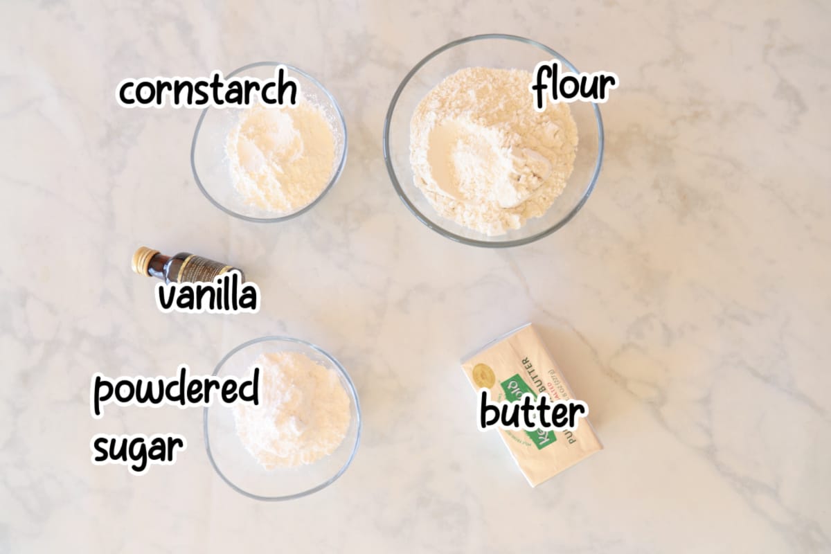 Shortbread cookies ingredients on a marble surface.
