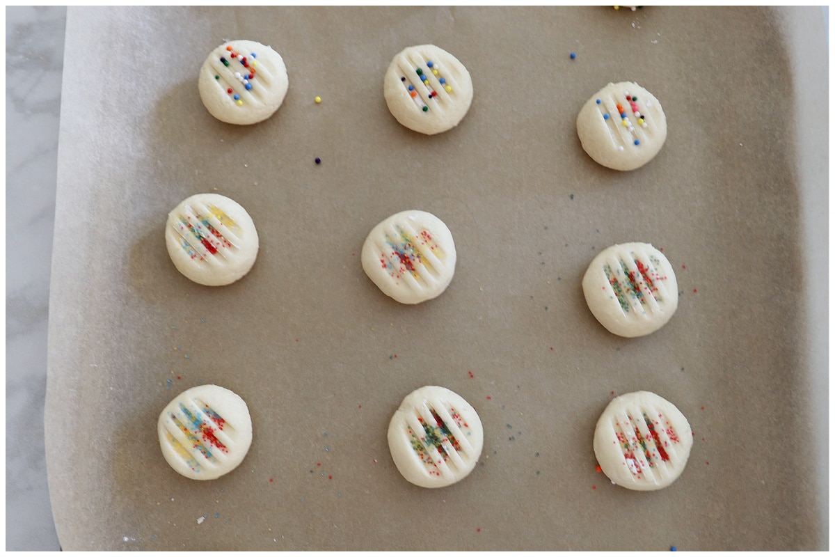 Cookie dough balls on a baking sheet.