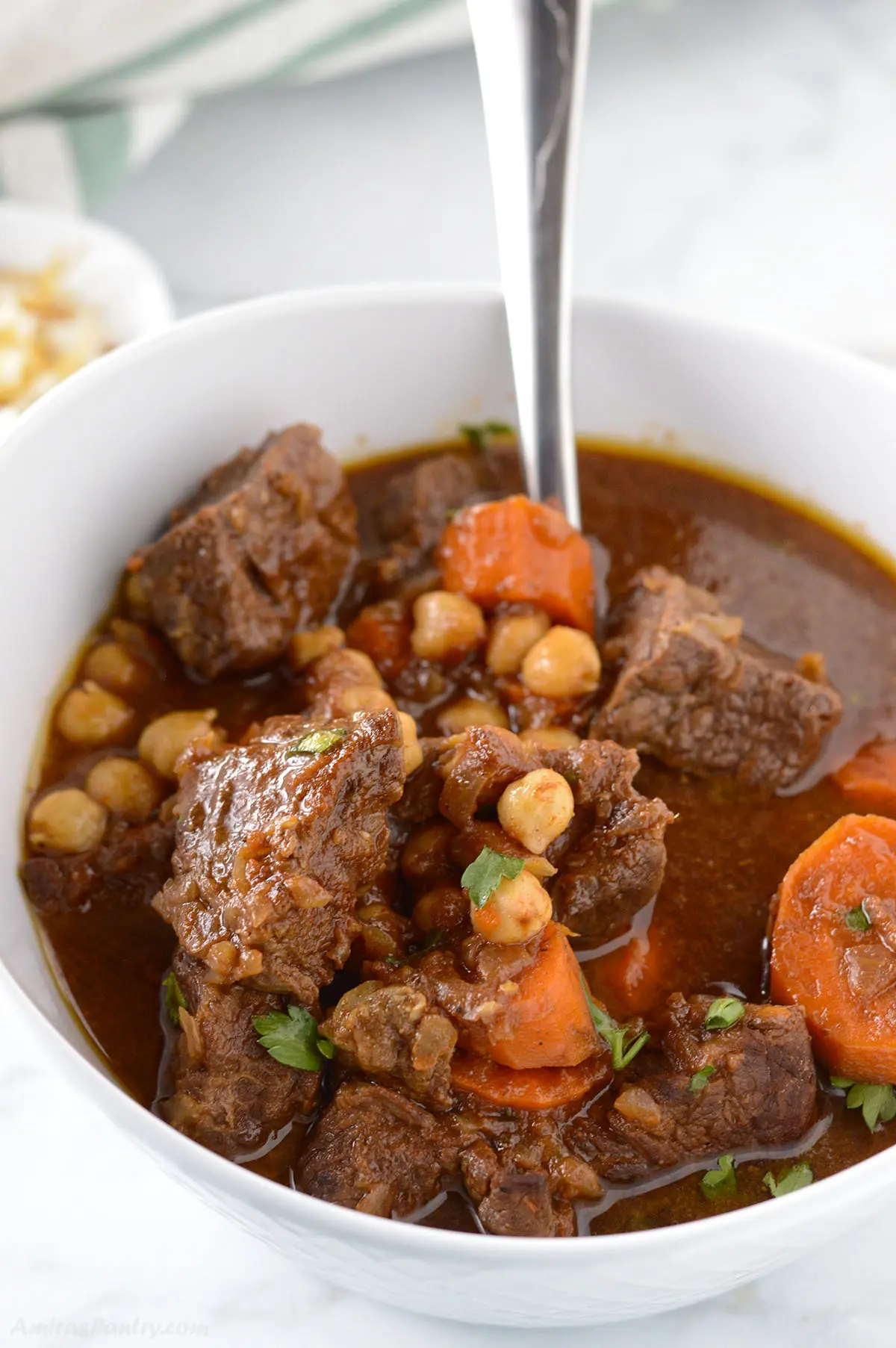 A big white bowl with gluten free beef stew.