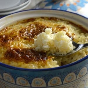 A clay pot with baked rice and chicken.