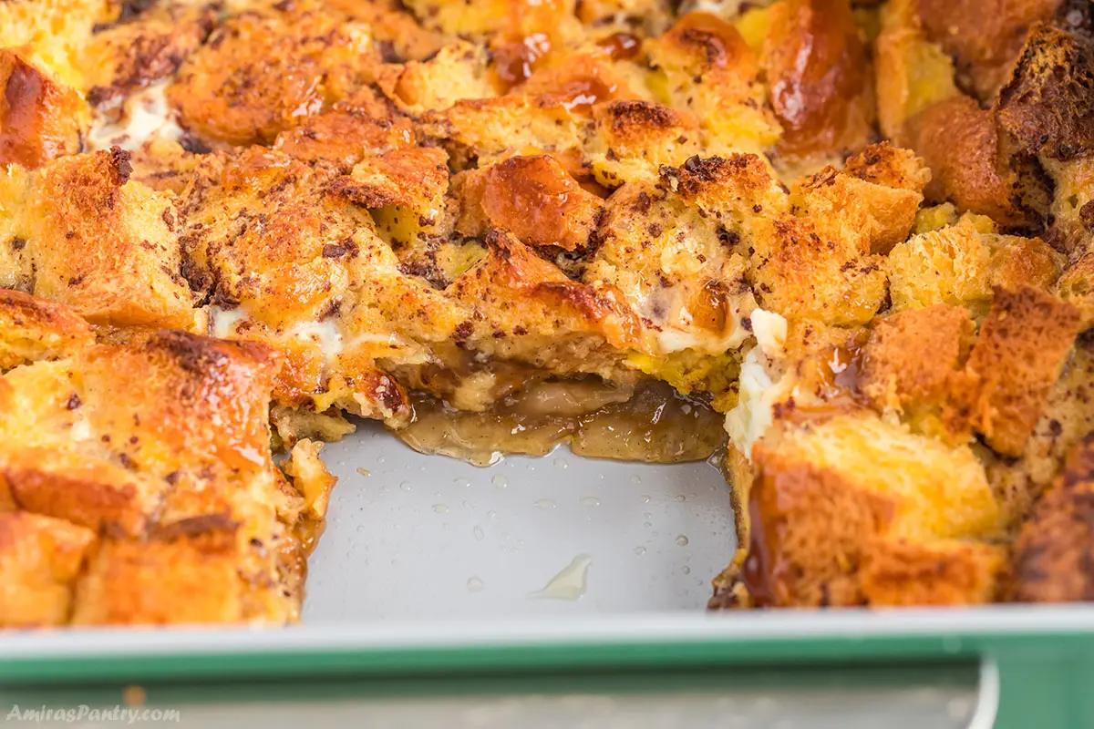 A brioche french toast casserole with a piece taken from it.