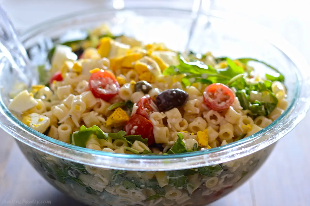 Cream pasta salad in a bowl with kalamata olives.