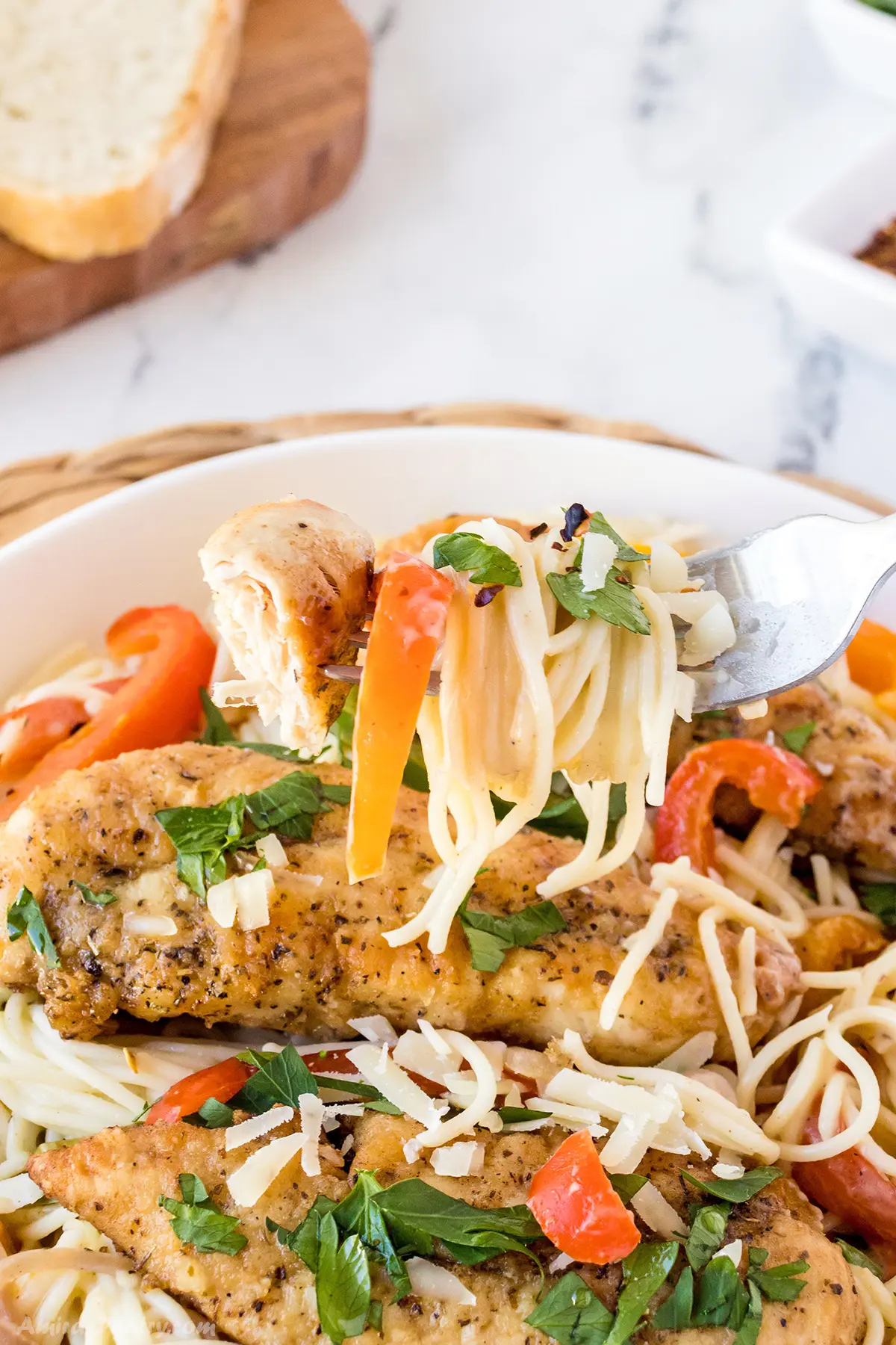 A fork with some chicken scampi pasta.