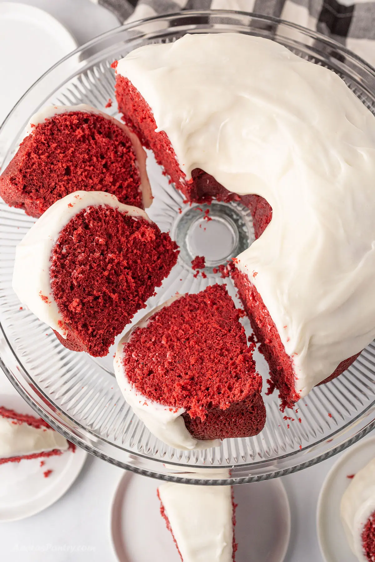 A top view of red velvet bundt with pieces cut to show texture.