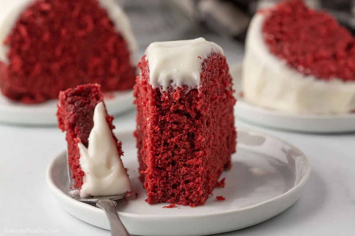 A piece of red velvet bundt cake on a white plate.