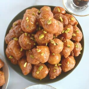 A top view of a serving plate with lokma balls.