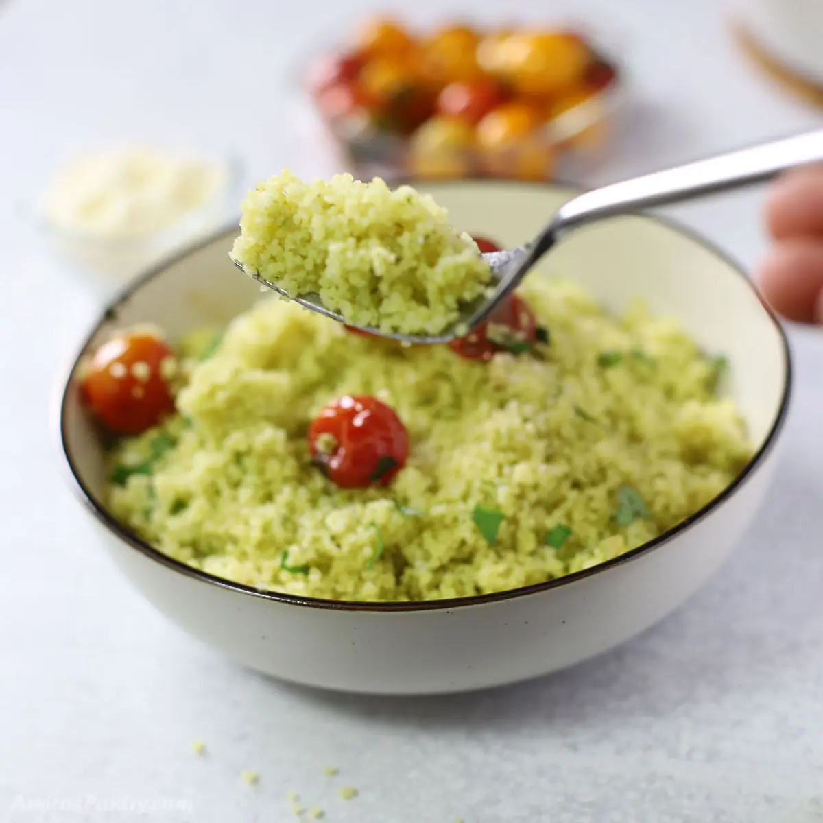 A fork with some pesto couscous.