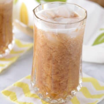 A close up look at a tall glass with tamarind juice.