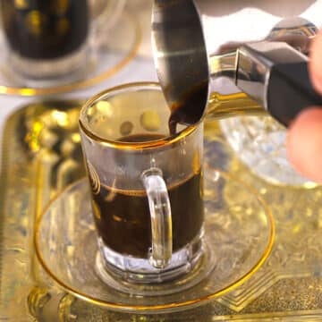Pouring some Turkish coffee in small cups.