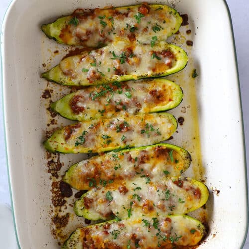 A top view of a casserole with zucchini boats.